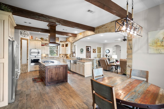 kitchen with kitchen peninsula, stainless steel appliances, ceiling fan, pendant lighting, and wood-type flooring