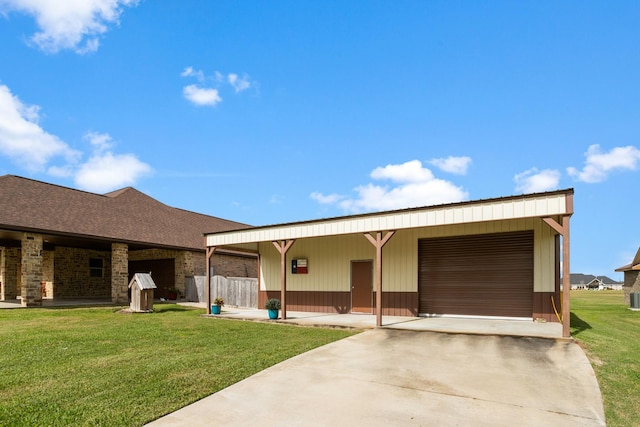 back of house featuring an outbuilding and a yard