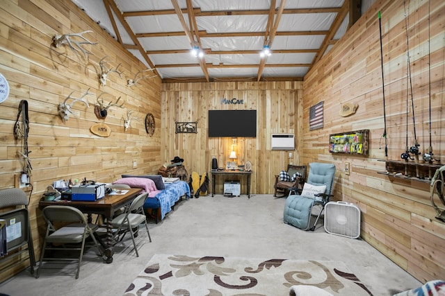 interior space featuring beamed ceiling, concrete flooring, and wooden walls