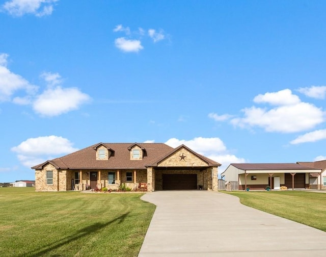 view of front of home with a garage and a front lawn