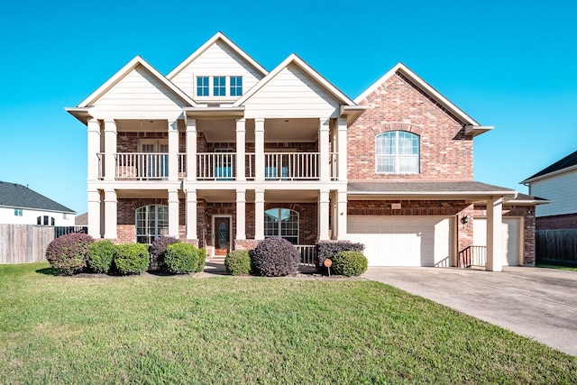 view of front of property with a balcony, a front yard, and a garage