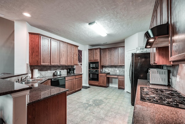 kitchen featuring kitchen peninsula, decorative backsplash, sink, black appliances, and dark stone countertops