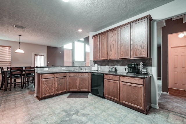 kitchen with pendant lighting, backsplash, black dishwasher, a textured ceiling, and kitchen peninsula