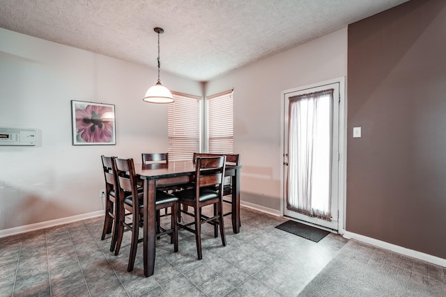 dining space featuring a textured ceiling