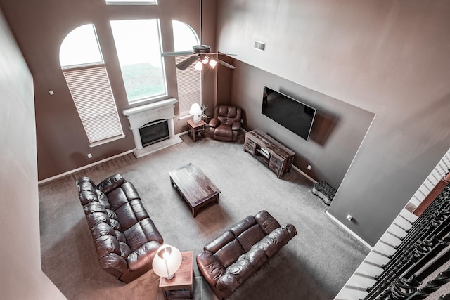 living room with carpet flooring, a high ceiling, and ceiling fan