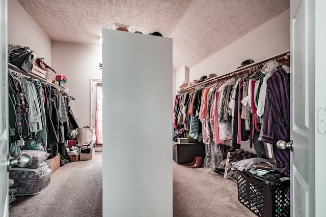 spacious closet with carpet and lofted ceiling