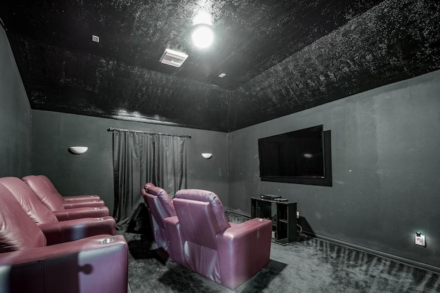 carpeted home theater room with vaulted ceiling