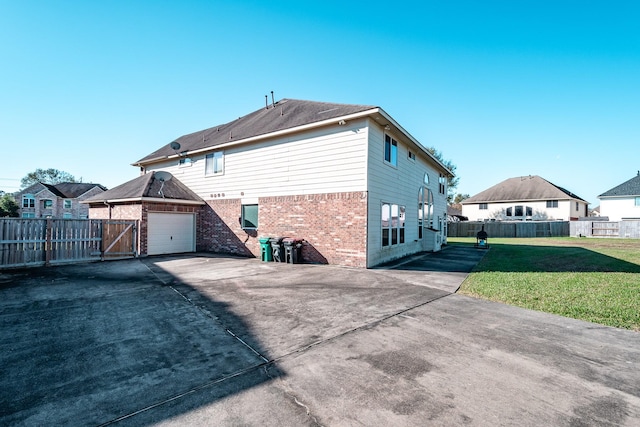 view of side of property with a yard and a garage