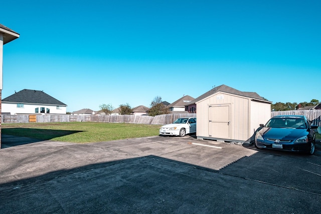 view of parking with a lawn