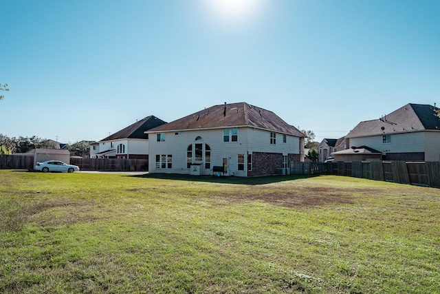 rear view of house with a yard