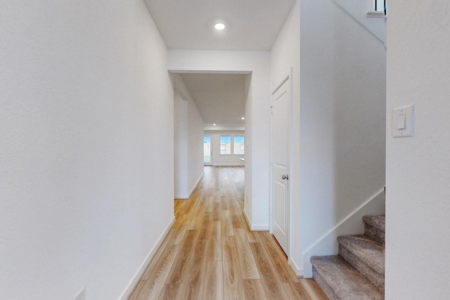 corridor with light hardwood / wood-style floors