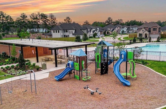 playground at dusk with a community pool