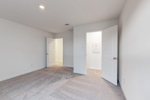 unfurnished bedroom featuring light colored carpet