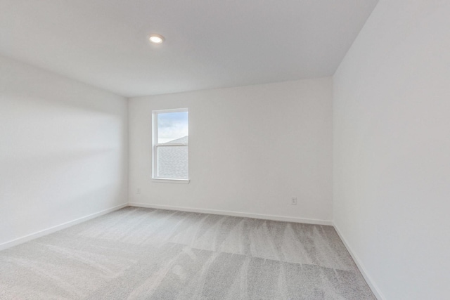 spare room with light colored carpet