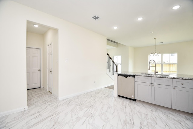 kitchen featuring gray cabinetry, light stone countertops, dishwasher, sink, and hanging light fixtures