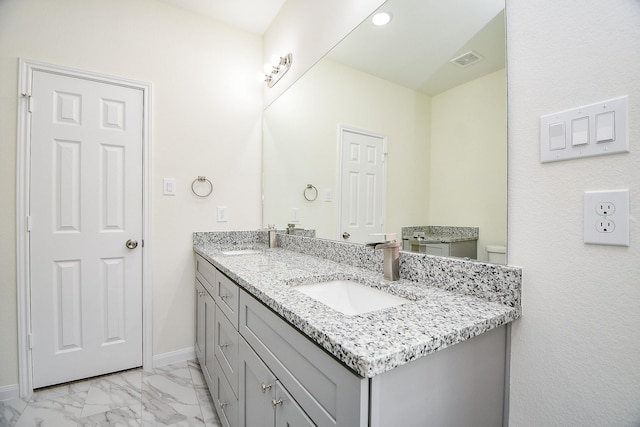 bathroom featuring vanity and toilet