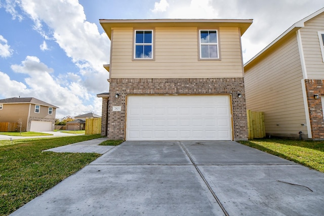 front of property featuring a front yard and a garage