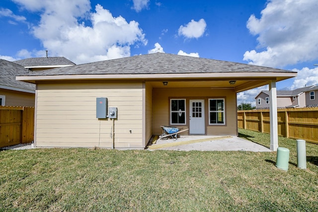 back of house featuring a yard and a patio