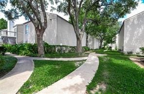 view of home's community with a yard