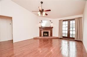 unfurnished living room featuring wood-type flooring, french doors, and ceiling fan