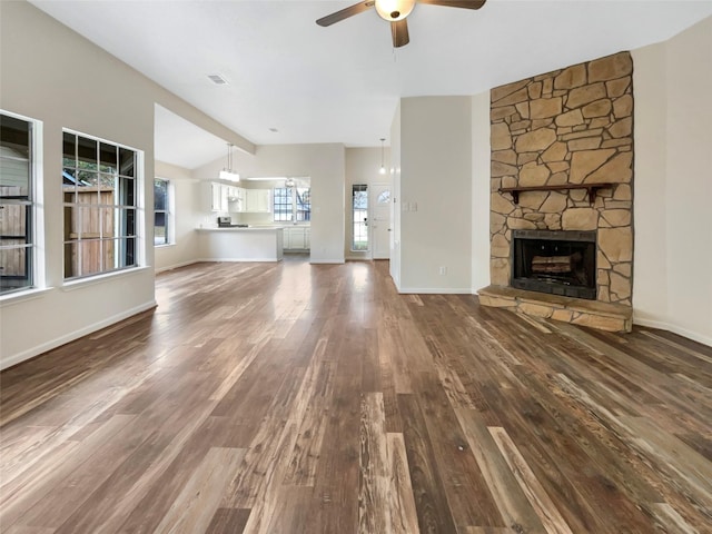 unfurnished living room with a fireplace, hardwood / wood-style floors, ceiling fan, and lofted ceiling