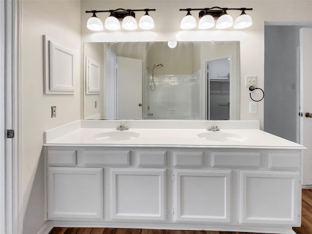 bathroom featuring vanity, wood-type flooring, and walk in shower