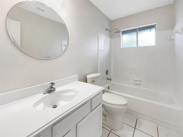 full bathroom with tile patterned flooring, vanity, tiled shower / bath combo, and toilet