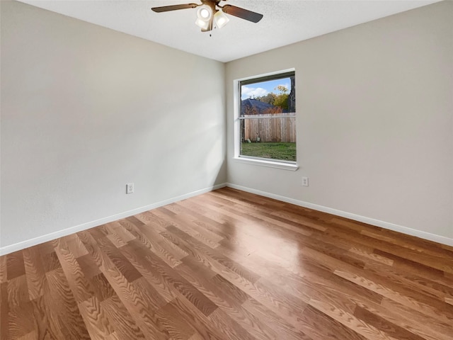 unfurnished room with ceiling fan and wood-type flooring