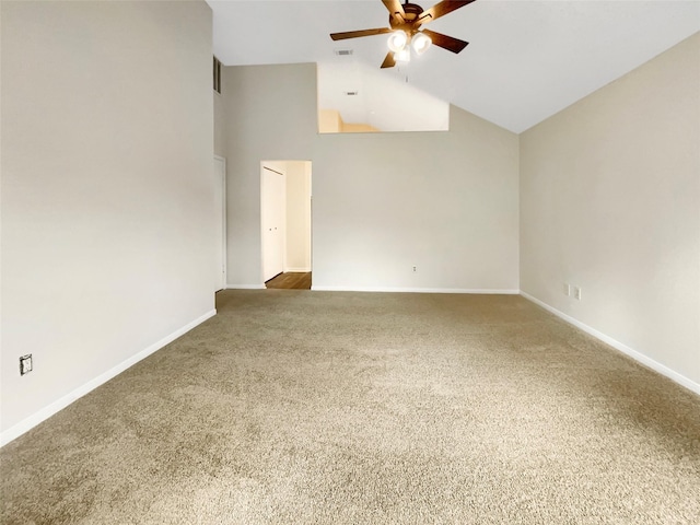 spare room with ceiling fan, carpet floors, and high vaulted ceiling