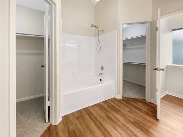 bathroom with hardwood / wood-style flooring and tub / shower combination