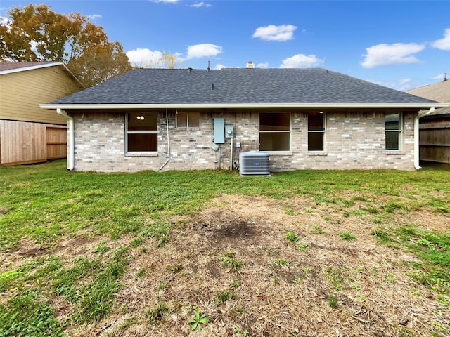 back of property with cooling unit and a yard