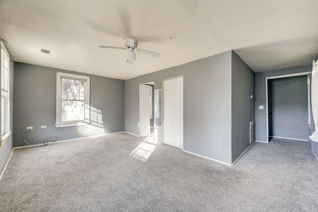 spare room featuring light colored carpet and ceiling fan