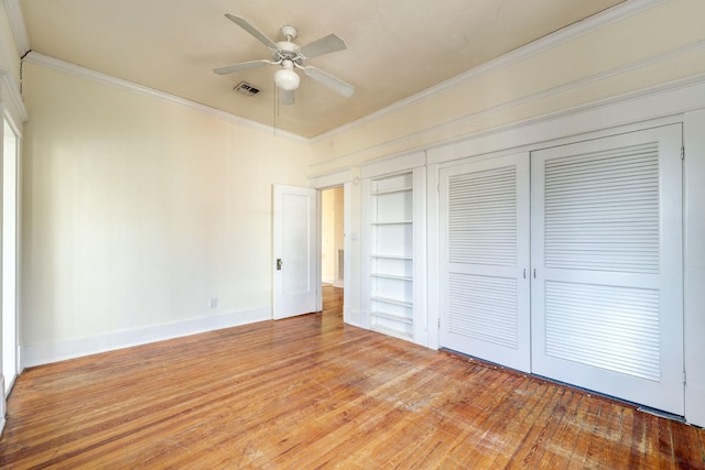 unfurnished bedroom with a closet, ceiling fan, light hardwood / wood-style flooring, and ornamental molding