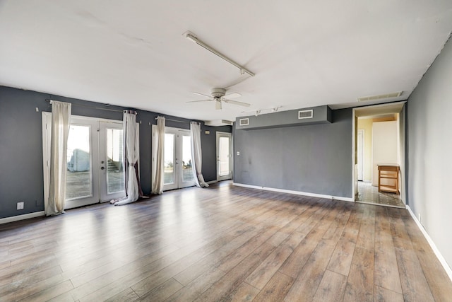 interior space featuring hardwood / wood-style floors, ceiling fan, and french doors