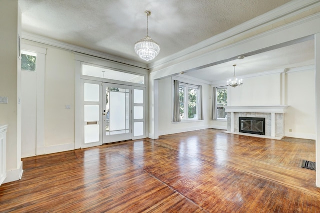 unfurnished living room with dark hardwood / wood-style flooring and an inviting chandelier