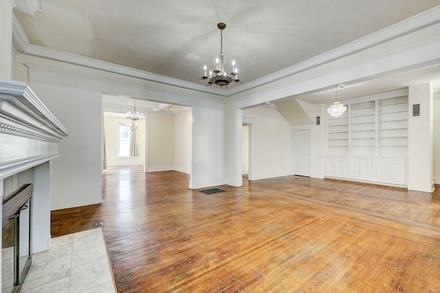 unfurnished living room featuring a tile fireplace, wood-type flooring, and crown molding