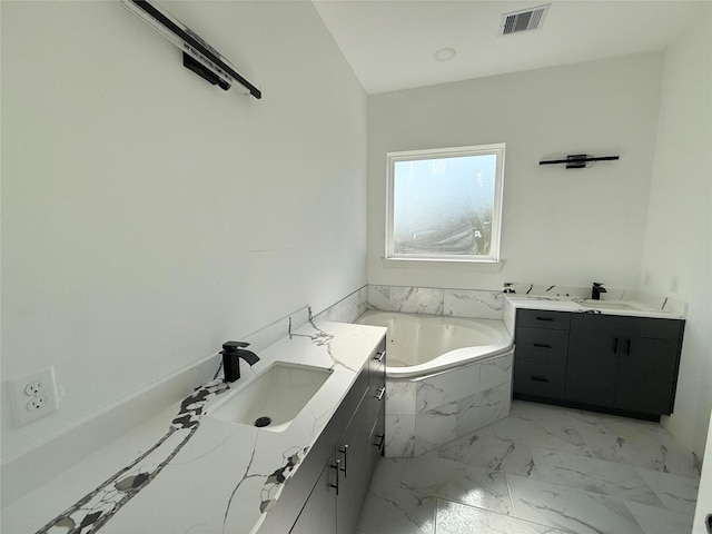 bathroom with vanity and a relaxing tiled tub