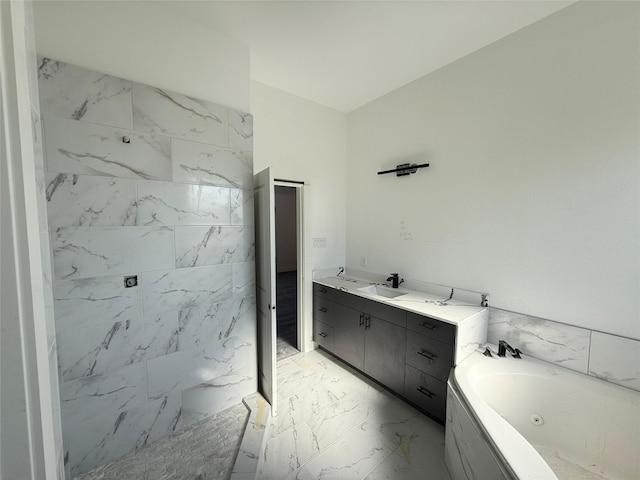 bathroom with vanity and a bath