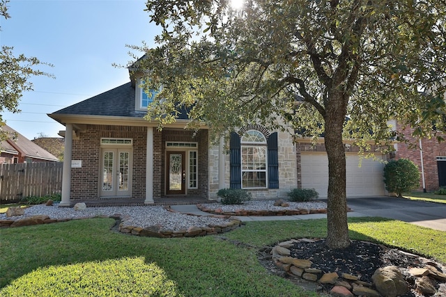 view of front of house with a porch, a garage, and a front lawn