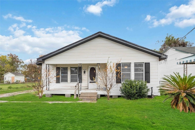 bungalow featuring a front lawn and a porch