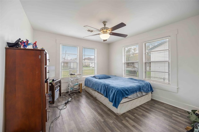 bedroom with ceiling fan and dark hardwood / wood-style flooring