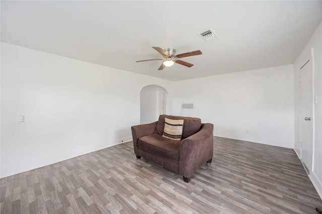 living area with ceiling fan and light hardwood / wood-style floors