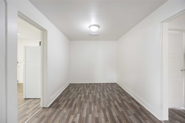 unfurnished room featuring dark wood-type flooring