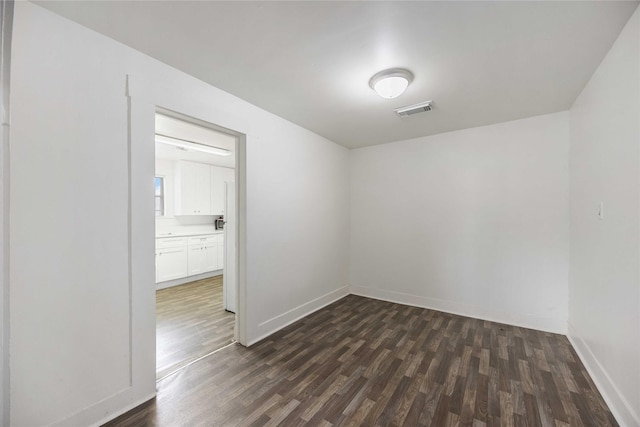 unfurnished room with dark hardwood / wood-style floors