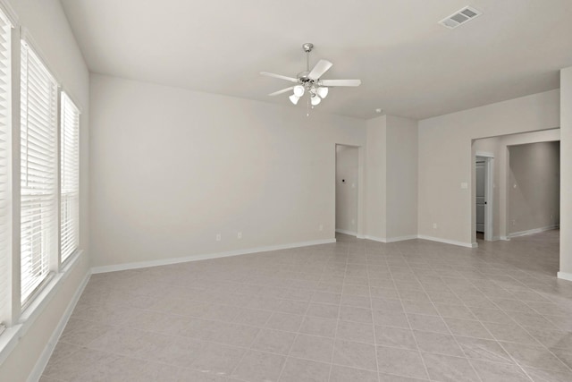 unfurnished room featuring plenty of natural light and ceiling fan