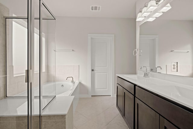 bathroom featuring tile patterned floors, vanity, and independent shower and bath