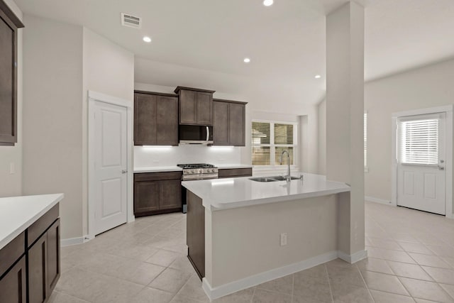 kitchen featuring light tile patterned flooring, appliances with stainless steel finishes, a healthy amount of sunlight, and sink