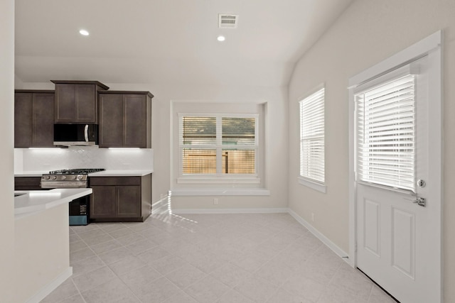 kitchen featuring decorative backsplash, dark brown cabinetry, and stainless steel appliances