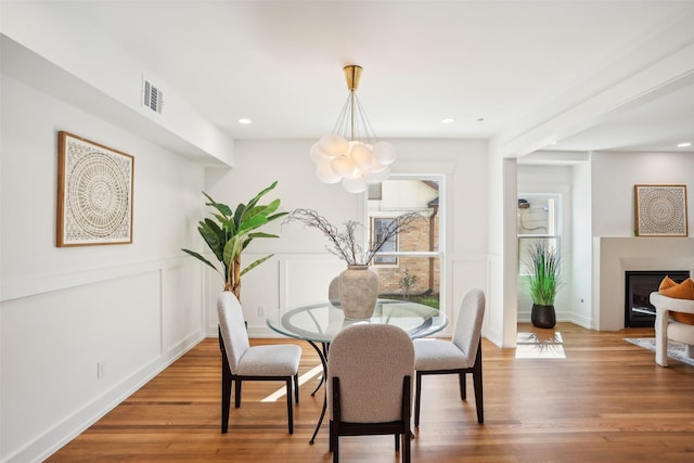 dining room with hardwood / wood-style flooring and an inviting chandelier