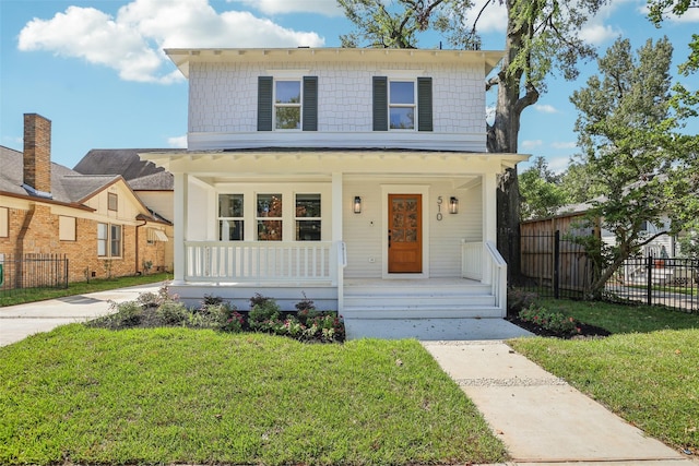 view of front of home with a front yard and a porch